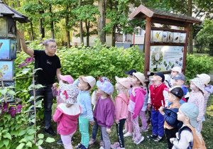 Dzieci oglądają tablice edukacyjne dotyczące ptaków, ich upierzenia, pokarmu i jaj