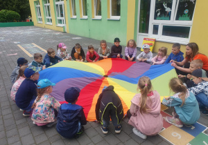 Dzieci bawią się z chustą animacyjną.