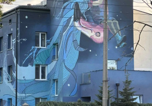 uczestnicy gry terenowej oglądają mural na budynku Fundacji Gajusz