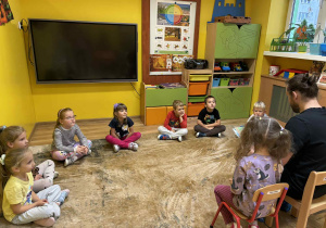 tata Idy czyta dzieciom książkę