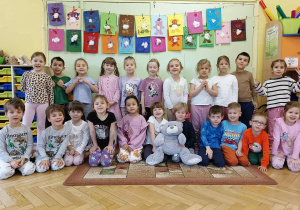 Dzieci z grupy żółtej pozują do zdjęcia z wykonanymi przez siebie misiami