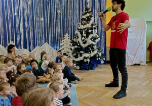 dzieci siedzą w sali, słuchają opowieści Pana Jacka