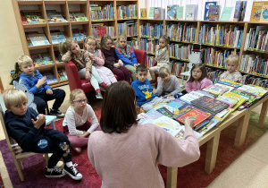 dzieci słuchają czytanej przez p. Małgosię książki o zwyczajach świątecznych,