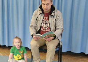 Tata czyta książkę.