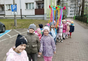 dzieci spacerują w okolicy naszego przedszkola, śpiewają piosenki o wiośnie