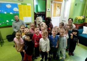 dzieci pozują do zdjęcia z alpakami