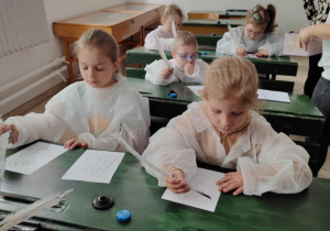 dzieci piszą gęsim piórem,