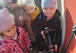 Dzieci oglądają końcówkę węża strażackiego